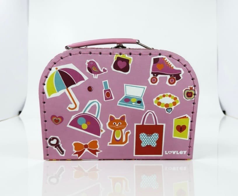 Closed pink LOVLEY suitcase covered in colourful stickers, umbrella, rollerskate, cat, bow, lipstick, sat on a white table.