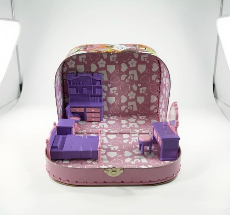 A purple four-poster miniature bed has been placed against the left wall. Everything else has shifted slightly to make room for it.