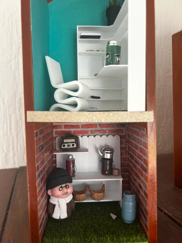 Miniature Granda on a Shelf scene with seated grandfather figure.