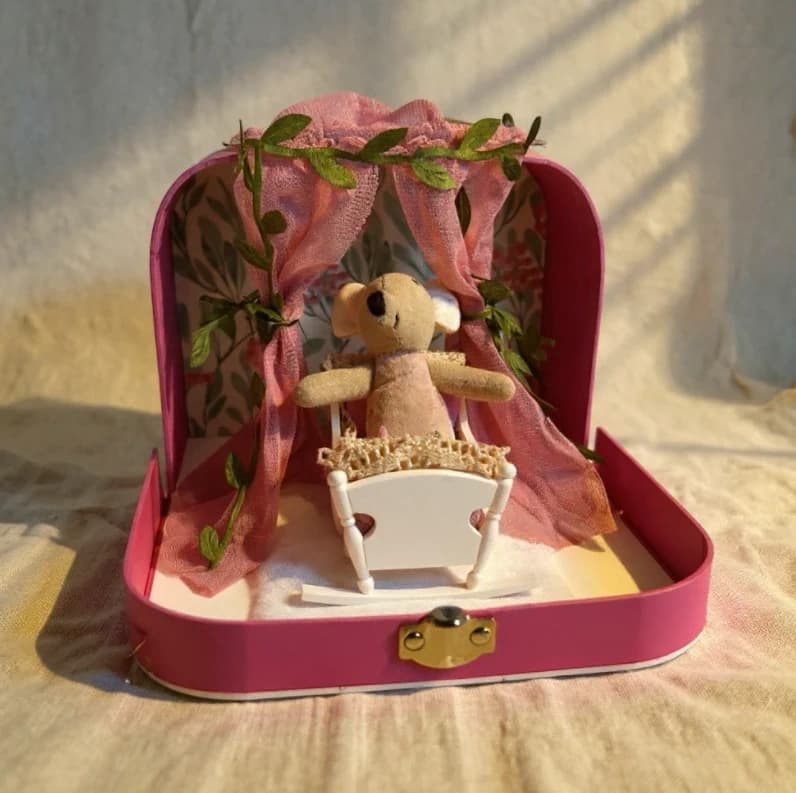 A miniature nursery scene with a tiny cradle, the kind of setup a beginner Maileg collector might build around.
